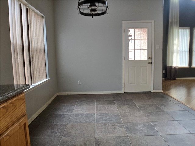 3905 Austin Lake Ct, Pearland, TX 77581 - unfurnished dining area featuring baseboards and plenty of natural light