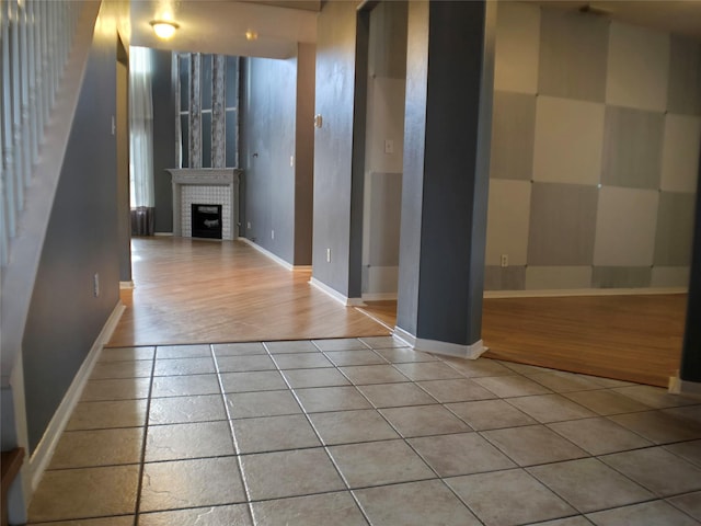 3905 Austin Lake Ct, Pearland, TX 77581 - interior space featuring baseboards, light tile patterned flooring, and a fireplace