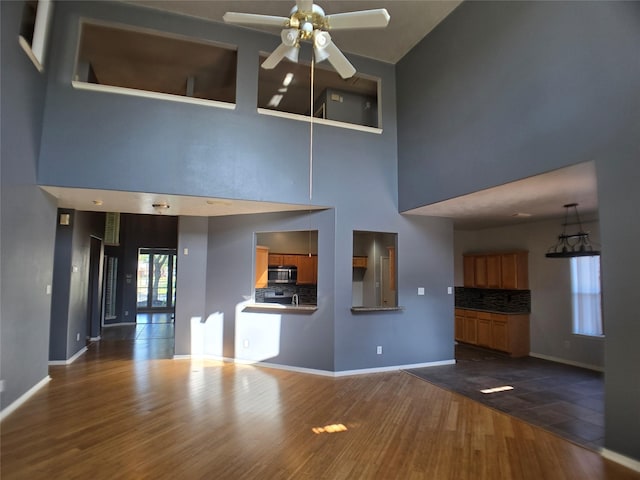 3905 Austin Lake Ct, Pearland, TX 77581 - unfurnished living room featuring baseboards, a ceiling fan, and dark wood finished floors