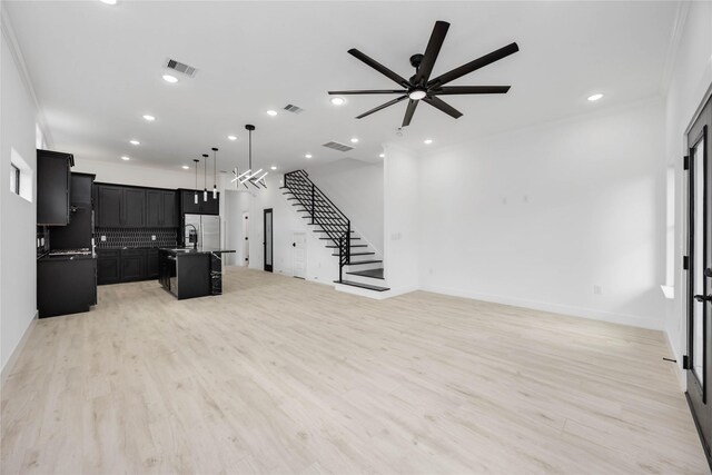 3020 Retta St, Houston, TX 77026 - unfurnished living room featuring stairway, light wood-style floors, a ceiling fan, and visible vents
