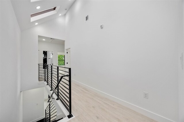 3020 Retta St, Houston, TX 77026 - corridor featuring visible vents, baseboards, high vaulted ceiling, an upstairs landing, and a skylight