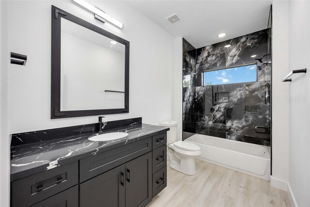 3020 Retta St, Houston, TX 77026 - full bath with vanity, toilet, tub / shower combination, wood finished floors, and visible vents