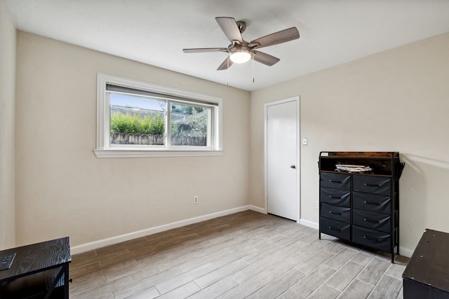 unfurnished bedroom with light wood-style floors, baseboards, and ceiling fan