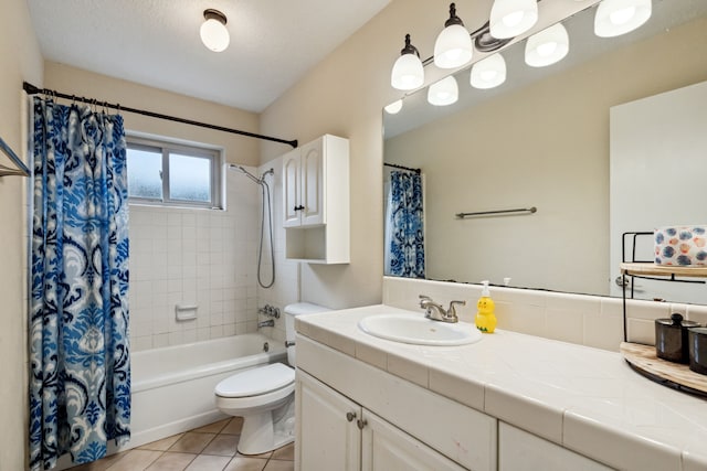 bathroom featuring toilet, tile patterned floors, vanity, and shower / bath combo with shower curtain