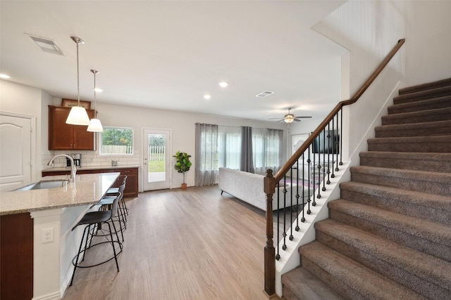 1202 Casal Springs Ct, Crosby, TX 77532 - stairway featuring recessed lighting, a ceiling fan, visible vents, and wood finished floors