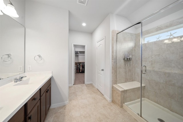 1202 Casal Springs Ct, Crosby, TX 77532 - bathroom with vanity, baseboards, a spacious closet, visible vents, and a stall shower