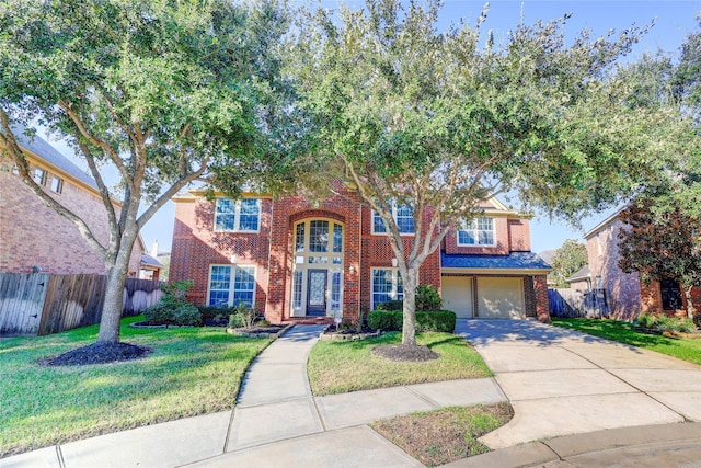 5507 Opal Cove Ct, Katy, TX 77494 - view of front of home with brick siding, fence, driveway, and a front lawn