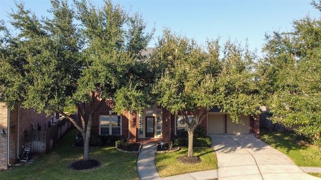 5507 Opal Cove Ct, Katy, TX 77494 - obstructed view of property with brick siding, fence, driveway, and a front yard