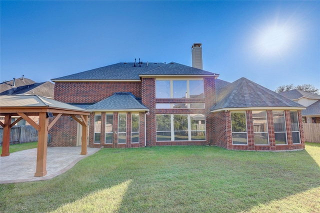5507 Opal Cove Ct, Katy, TX 77494 - back of house featuring fence, a gazebo, a chimney, a patio area, and a yard