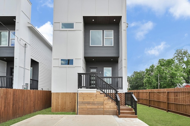 rear view of property featuring stairway