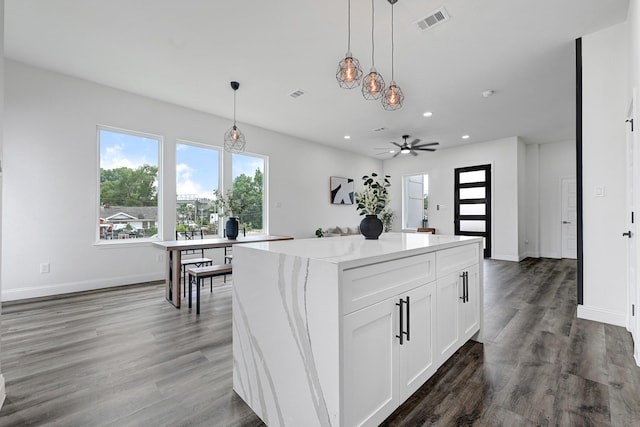 kitchen with a kitchen island, recessed lighting, hanging light fixtures, white cabinetry, and ceiling fan