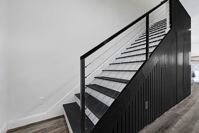 stairs featuring wood finished floors