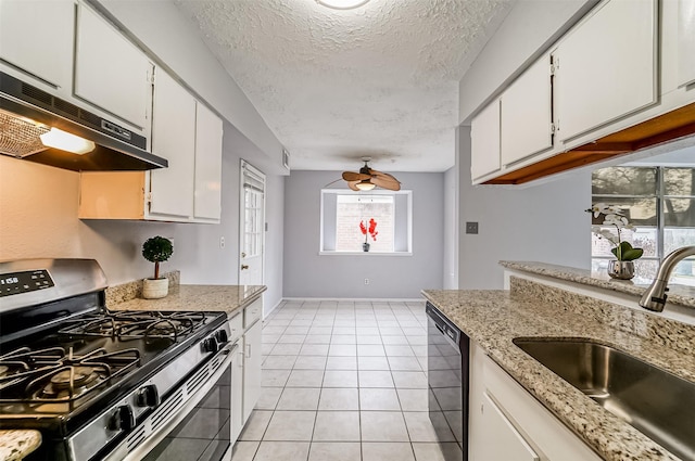 kitchen with stainless steel gas range oven, a textured ceiling, under cabinet range hood, a sink, and dishwasher