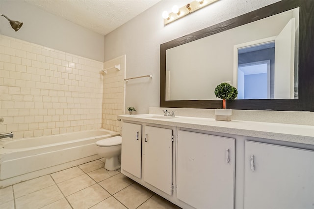 bathroom featuring a textured ceiling, tile patterned floors, vanity, toilet, and washtub / shower combination