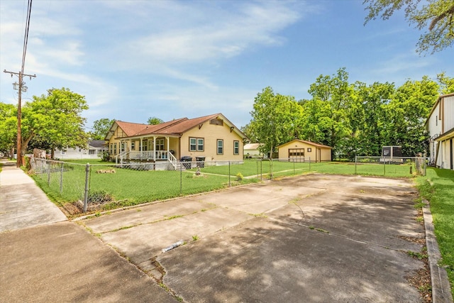 504 S Jackson St, Alvin, TX 77511 - view of front of property featuring concrete driveway, a front yard, a fenced front yard, and covered porch