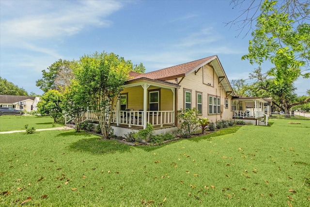 504 S Jackson St, Alvin, TX 77511 - view of property exterior featuring covered porch and a yard