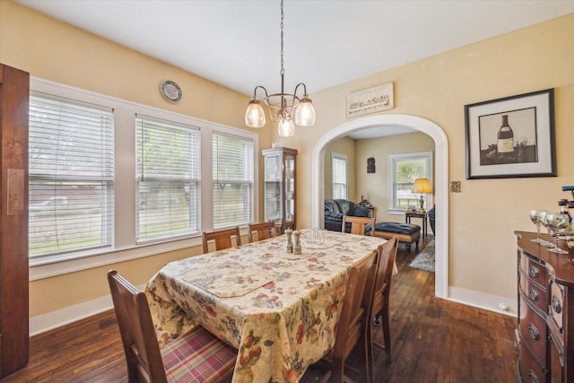 504 S Jackson St, Alvin, TX 77511 - dining room with baseboards, dark wood-style flooring, a notable chandelier, and arched walkways