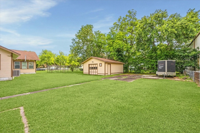 504 S Jackson St, Alvin, TX 77511 - view of yard featuring fence, cooling unit, and an outbuilding