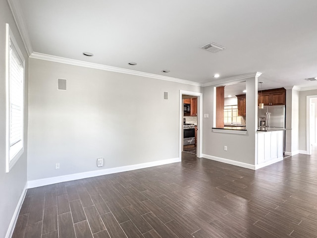 unfurnished living room featuring baseboards, ornamental molding, and visible vents