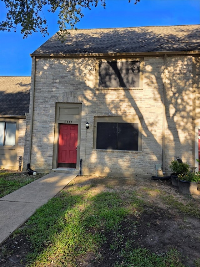 6444 Kentwick Dr Unit 24/13, Houston, TX 77084 - view of exterior entry featuring roof with shingles and brick siding