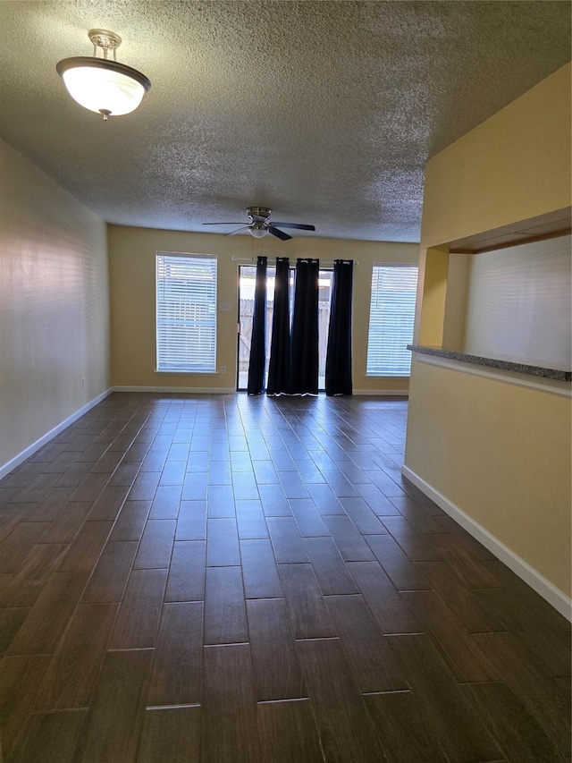 6444 Kentwick Dr Unit 24/13, Houston, TX 77084 - unfurnished room featuring wood tiled floor, a textured ceiling, and a wealth of natural light