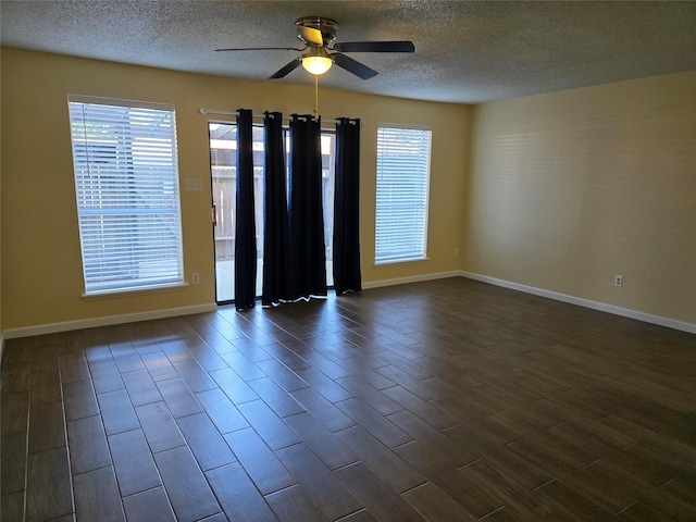 6444 Kentwick Dr Unit 24/13, Houston, TX 77084 - empty room with baseboards, ceiling fan, a textured ceiling, and dark wood-type flooring