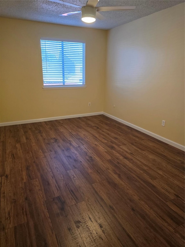 6444 Kentwick Dr Unit 24/13, Houston, TX 77084 - spare room featuring a ceiling fan, baseboards, dark wood-style floors, and a textured ceiling