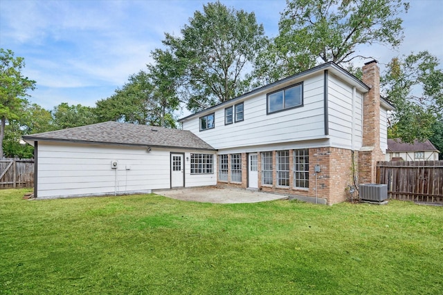 rear view of property featuring a yard, a patio, fence, and a chimney