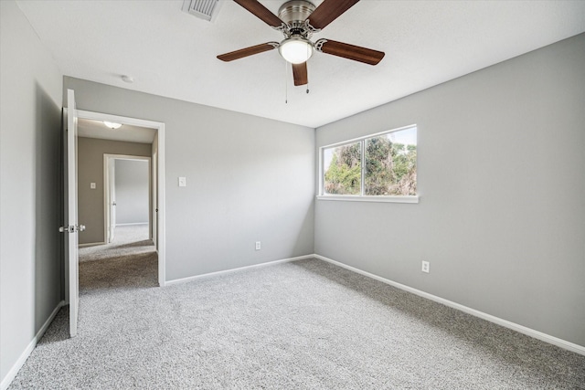 unfurnished room featuring baseboards, ceiling fan, carpet flooring, and visible vents