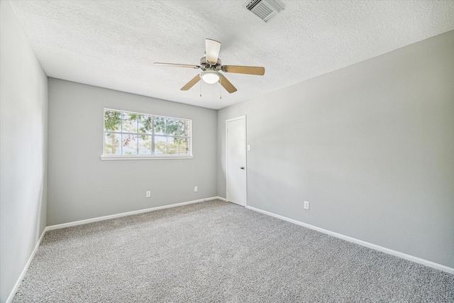 carpeted spare room featuring visible vents, a ceiling fan, a textured ceiling, and baseboards