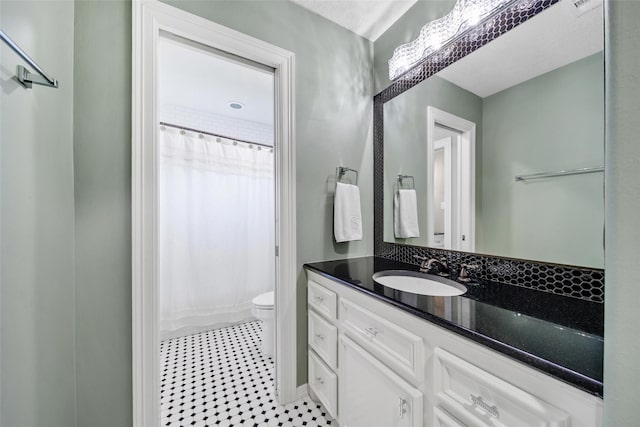 bathroom with vanity, toilet, and a shower with shower curtain