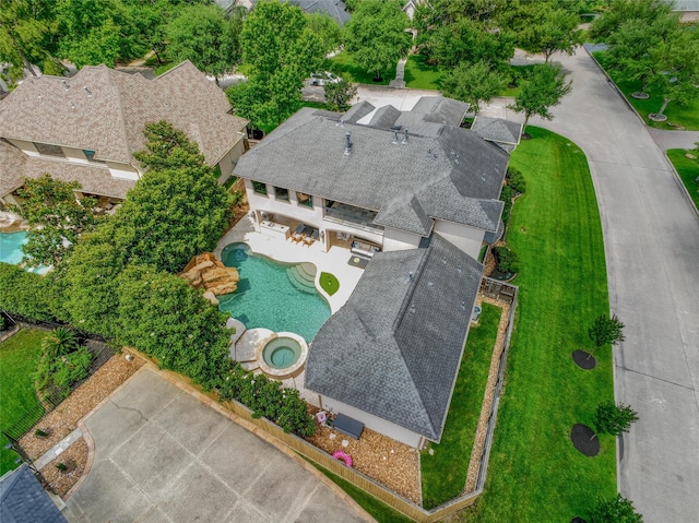 aerial view of property and surrounding area featuring a pool