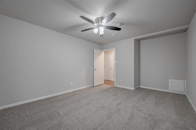 unfurnished bedroom with baseboards, ceiling fan, carpet floors, and visible vents