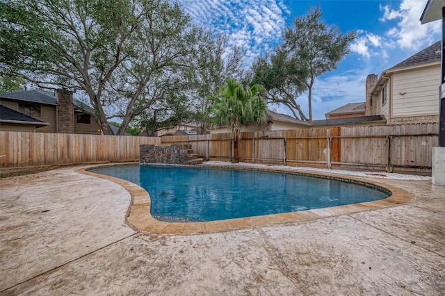 view of swimming pool featuring a fenced in pool, a fenced backyard, and a patio area