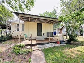 108 Nieman St, Yoakum, TX 77995 - back of house with board and batten siding and a yard