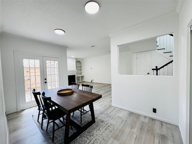 2323 Augusta Dr Unit 43, Houston, TX 77057 - dining area featuring crown molding, wood finished floors, french doors, baseboards, and stairs