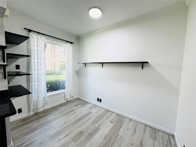 2323 Augusta Dr Unit 43, Houston, TX 77057 - washroom featuring crown molding, wood finished floors, and baseboards