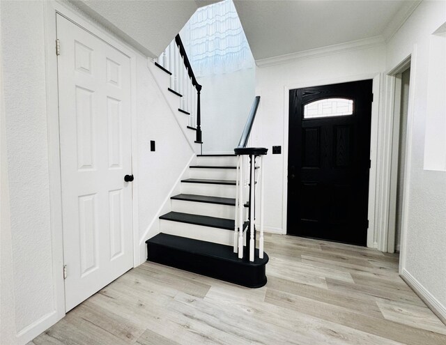 2323 Augusta Dr Unit 43, Houston, TX 77057 - foyer entrance with wood finished floors, crown molding, stairs, and baseboards