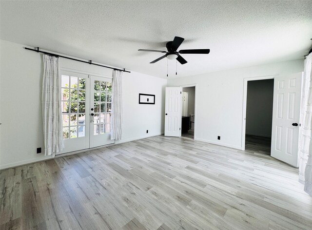 2323 Augusta Dr Unit 43, Houston, TX 77057 - unfurnished bedroom featuring light wood finished floors, french doors, a textured ceiling, baseboards, and ceiling fan