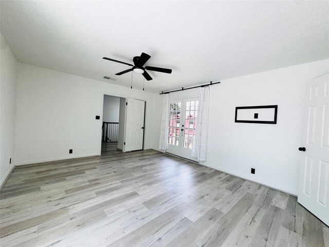 2323 Augusta Dr Unit 43, Houston, TX 77057 - unfurnished bedroom featuring light wood-style flooring, baseboards, a ceiling fan, and french doors