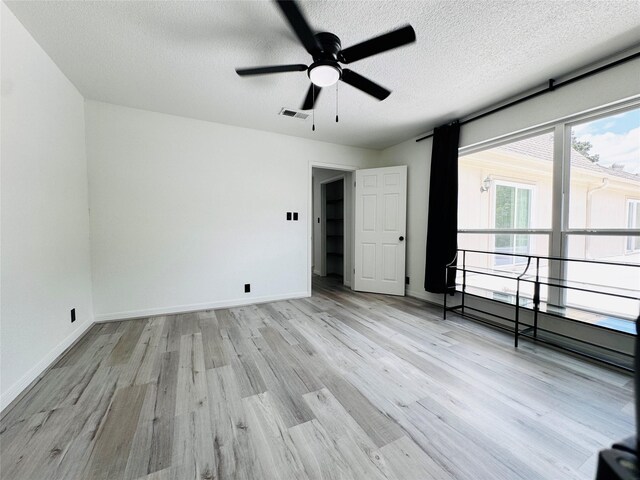 2323 Augusta Dr Unit 43, Houston, TX 77057 - unfurnished room featuring a ceiling fan, wood finished floors, a textured ceiling, and baseboards