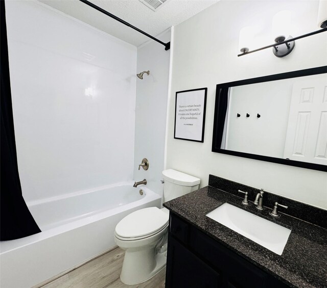 2323 Augusta Dr Unit 43, Houston, TX 77057 - bathroom featuring wood finished floors, shower / washtub combination, vanity, toilet, and a textured ceiling