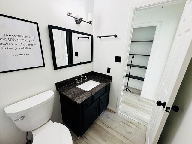 2323 Augusta Dr Unit 43, Houston, TX 77057 - bathroom featuring vanity, wood finished floors, toilet, and baseboards