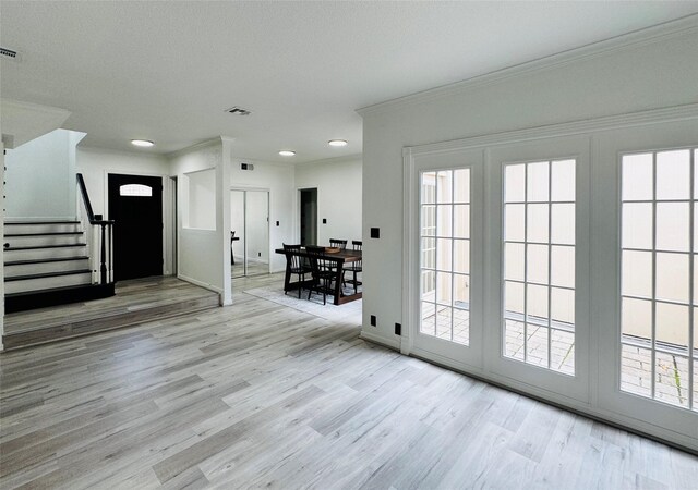 2323 Augusta Dr Unit 43, Houston, TX 77057 - foyer entrance with plenty of natural light, wood finished floors, crown molding, stairway, and recessed lighting