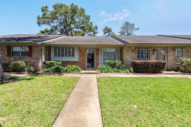 1016 E Tri Oaks Ln Unit 79, Houston, TX 77043 - single story home featuring brick siding, a shingled roof, and a front lawn