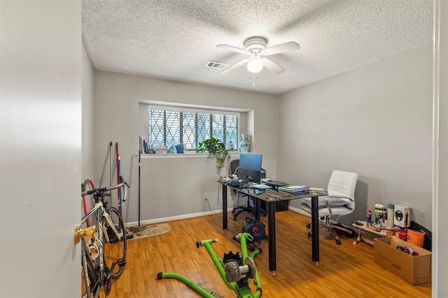 1016 E Tri Oaks Ln Unit 79, Houston, TX 77043 - office with wood finished floors, a ceiling fan, a textured ceiling, and visible vents