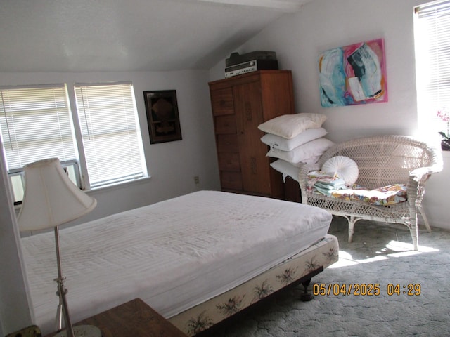 carpeted bedroom featuring lofted ceiling