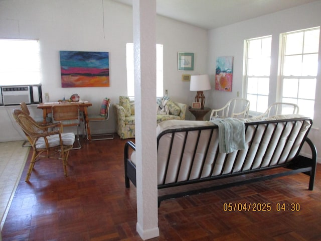 living room with cooling unit, vaulted ceiling, and a wealth of natural light