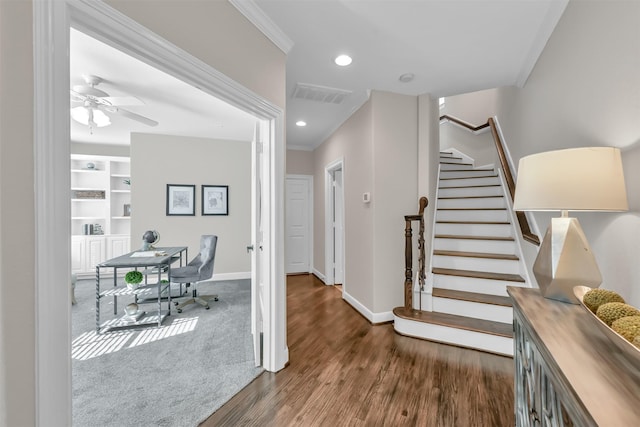 entrance foyer with ceiling fan, visible vents, wood finished floors, baseboards, and stairs