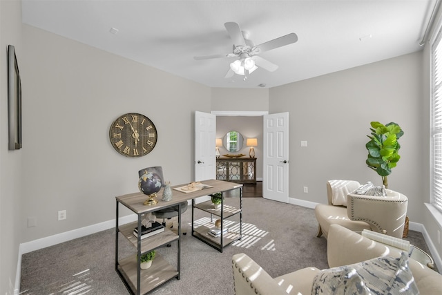 home office with baseboards, ceiling fan, and carpet